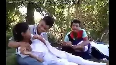 College couples enjoying outdoor kissing infront of their friends